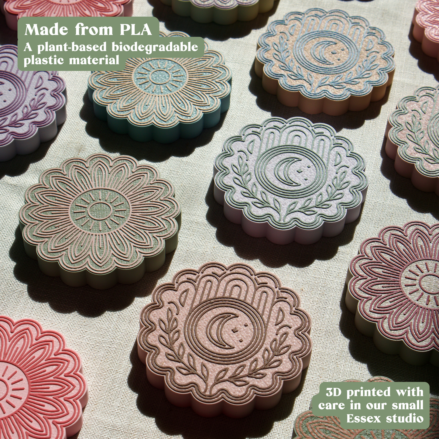 Decorative 3D-printed drink mats made from PLA material on a textured surface.