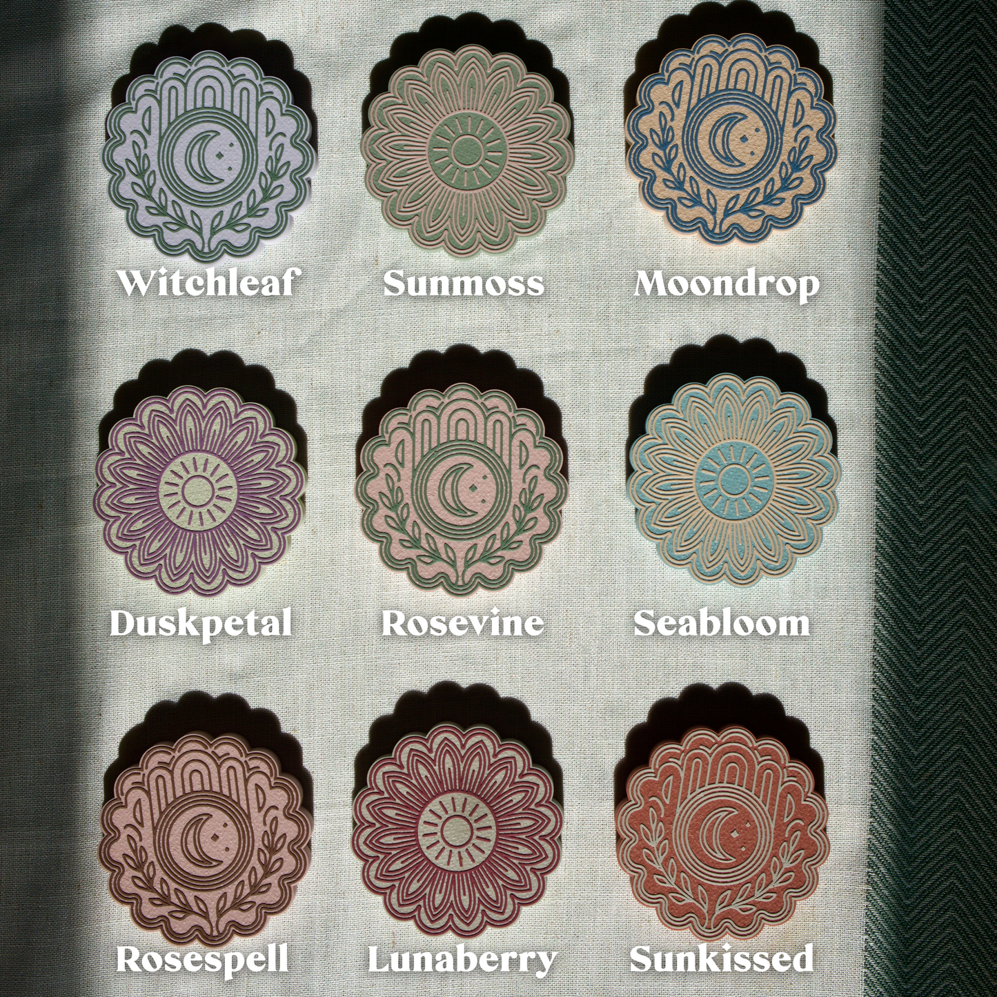 Set of nine floral designs labeled 'Witchleaf', 'Sunmoss', 'Moondrop', 'Duskpetal', 'Rosevine', 'Seabloom', 'Rosespell', 'Lunaberry', and 'Sunkissed' on a textured background.